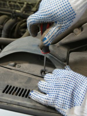 mechanic man with wrench repairing car at workshop mechanic man with wrench repairing car at workshop