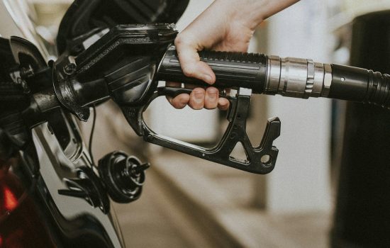 Woman filling petrol at a gas station